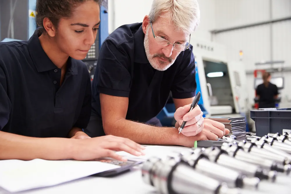 Engineer,and,apprentice,planning,cnc,machinery,project